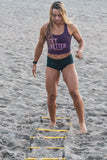 woman using BKX Agility Ladder on the sand